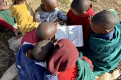 A group of kids reading the Bible together.