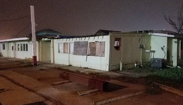 Building boarded up and tore apart after a storm