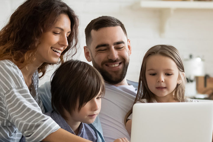 Family at home watching on a computer